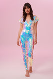 Front view of a woman wearing the Rosa Bloom Aphrodite jumpsuit embellished in hand sewn sparkly opal white sequins with a blue shine.