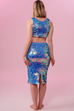 Back view of a blonde woman wearing a Rosa Bloom blue and pink sequin mid length sequin tube skirt