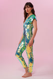 Dark haired model with long hair wearing a Rosa Bloom sequin Aphrodite jumpsuit in Chameleon