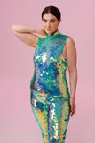 A woman with brown hair, wearing an all-in-one sequin stretchy festival jumpsuit made with large round holographic Rosa Bloom sequins. The Iris jumpsuit sequins glisten all over in this chameleon colour way, creating a mix of shimmering colours of soft mint green and sage that sparkles in the light.