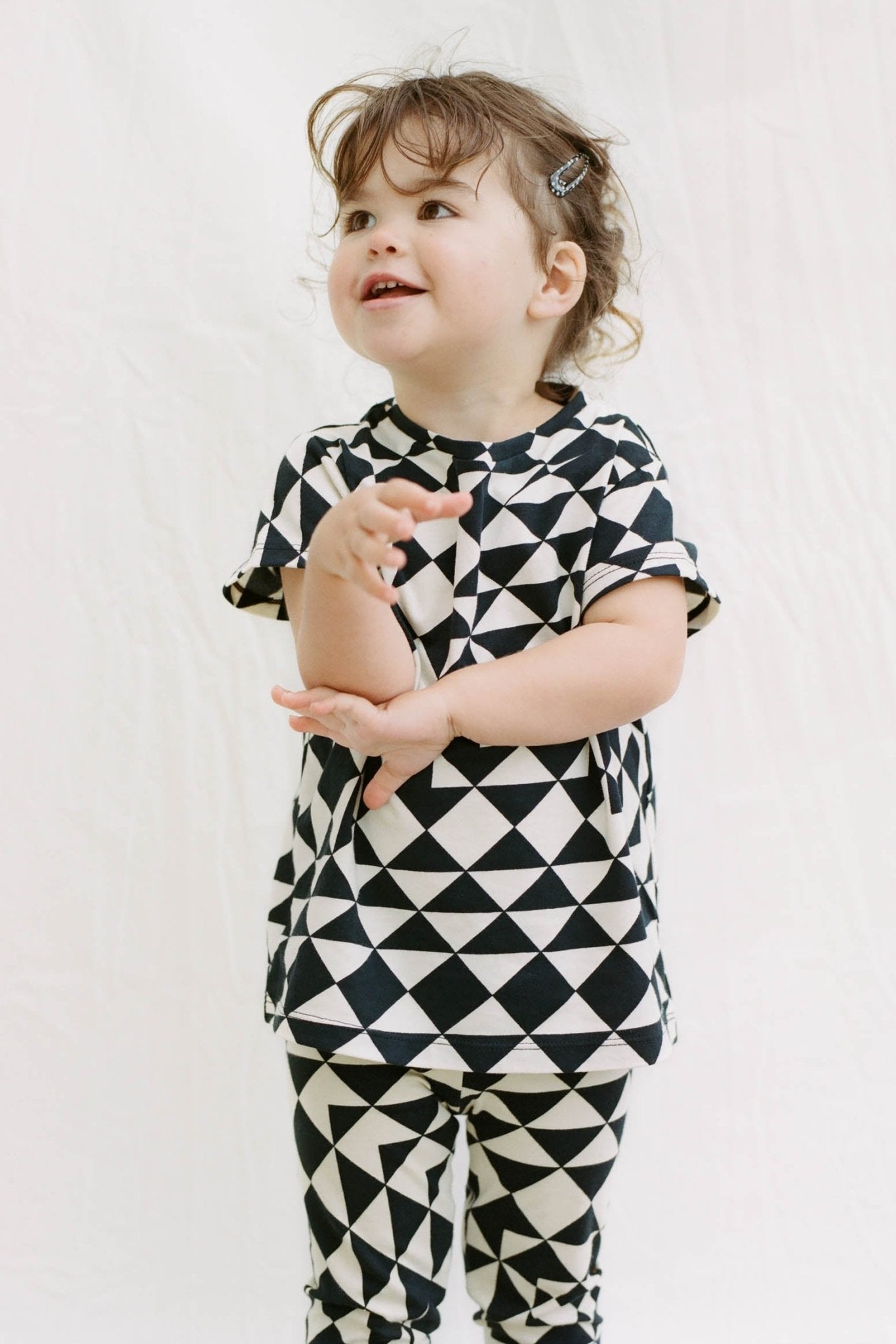 Child wearing geometric leggings and matching top