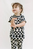 Child wearing geometric leggings and matching top