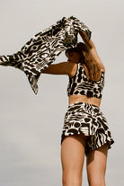 Twinks crop top in black and white with bold screen print. Includes matching shorts for a complete, stylish set.