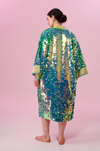 Dark haired model wearing a Rosa Bloom Chameleon Green Sequin Robe