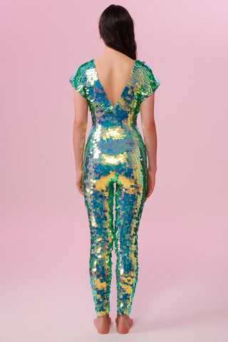 Dark haired model with long hair wearing a Rosa Bloom sequin Aphrodite jumpsuit in Chameleon