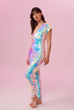 Side view of a woman wearing the Rosa Bloom Aphrodite jumpsuit embellished in hand sewn sparkly opal white sequins with a blue shine.