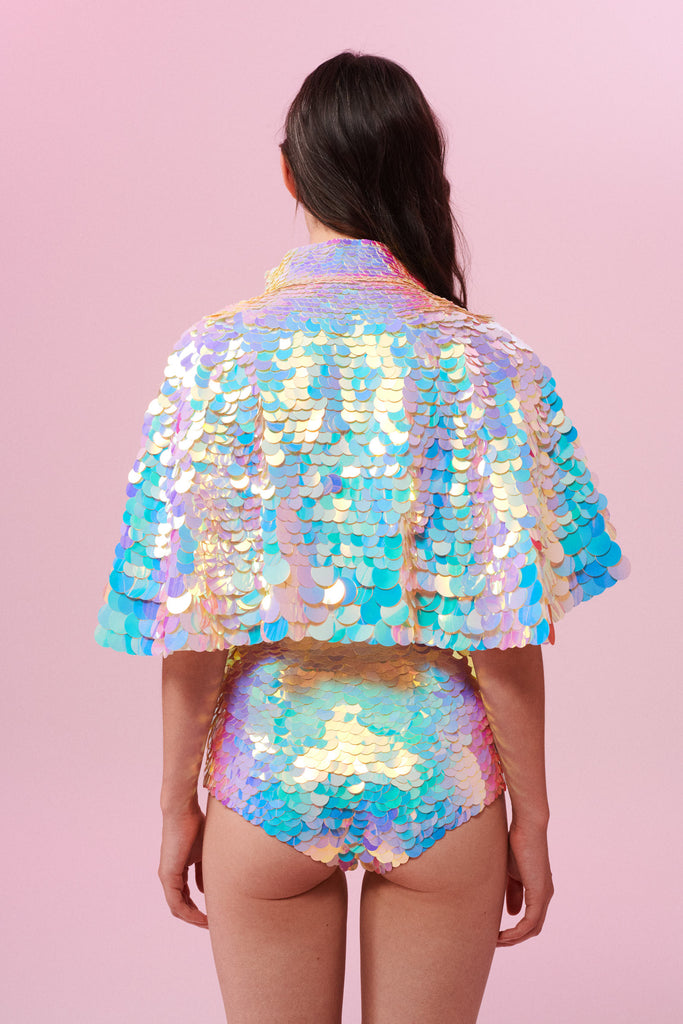 Back view of a woman wearing Rosa Bloom Shimmering Sequin Cape with Opal White sequins