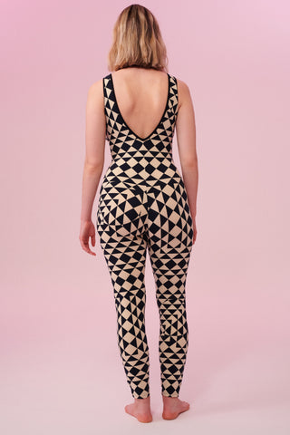 Rear view of a woman wearing a triangular print black and white Rosa Bloom jumpsuit