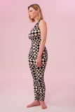 Side view of a woman wearing a triangular print black and white Rosa Bloom jumpsuit