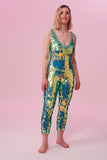 Front view of a woman wearing a green sequin Rosa Bloom jumpsuit
