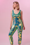 Front view of a woman wearing a green sequin Rosa Bloom jumpsuit