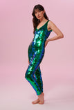 Side view of a woman wearing an emerald sequin Rosa Bloom jumpsuit