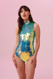 Model with  long, straight brown hair standing front wearing a pale green sequin Rosa Bloom Fifi Leotard