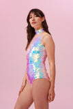 Long brown haired model posing side on  wearing an Opal coloured Rosa Bloom Sequin Fifi Leotard