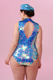 Model wearing a sequinned beret standing with their back to the camera wearing a pink and blue sequin Rosa Bloom Fifi Leotard