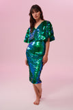 Model with long brown straight hair posing front on wearing an emerald green Rosa Bloom Georgie sequin skirt and a Rosa Bloom Emerald green sequin cape top