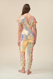 Back view of a woman wearing the Rosa Bloom Aphrodite jumpsuit embellished in hand sewn sparkly quartz pearl white sequins.