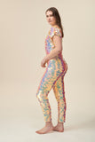 Side view of a woman wearing the Rosa Bloom Aphrodite jumpsuit embellished in hand sewn sparkly quartz pearl white sequins.