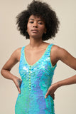 A close up of the front view of a woman wearing the Rosa Bloom Electra sequin jumpsuit in aqua blue showing the button detail.