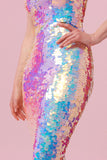 A crop of a figure with her hands on her hips, wearing a figure hugging long sequin dress completely covered in large round holographic Rosa Bloom sequins. The sequins glisten, creating a mix of shimmering colours of pink, blue, lilac and white.